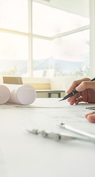 Hands of Engineer working on blueprint,Construction concept. Engineering tools.Vintage tone retro filter effect,soft focus(selective focus)